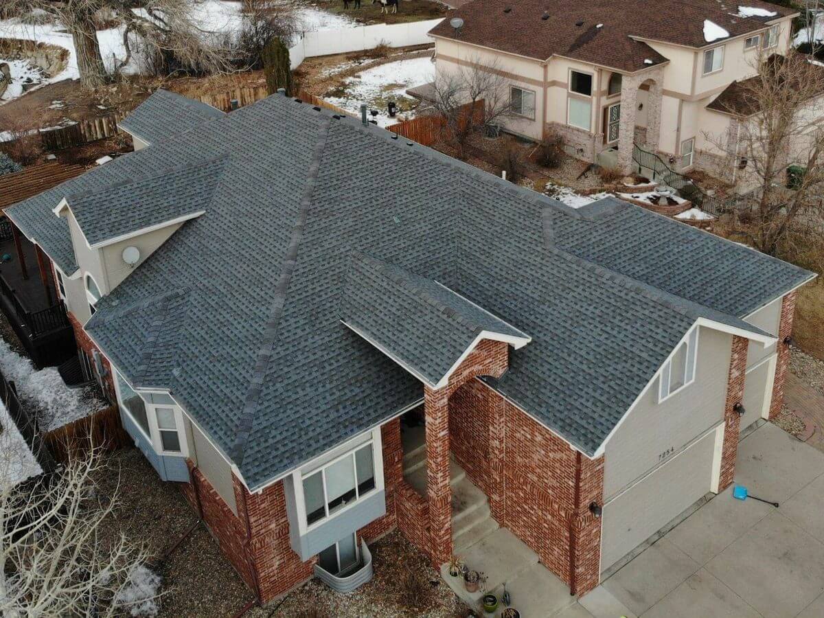 brick home Colorado winter house roof fixed