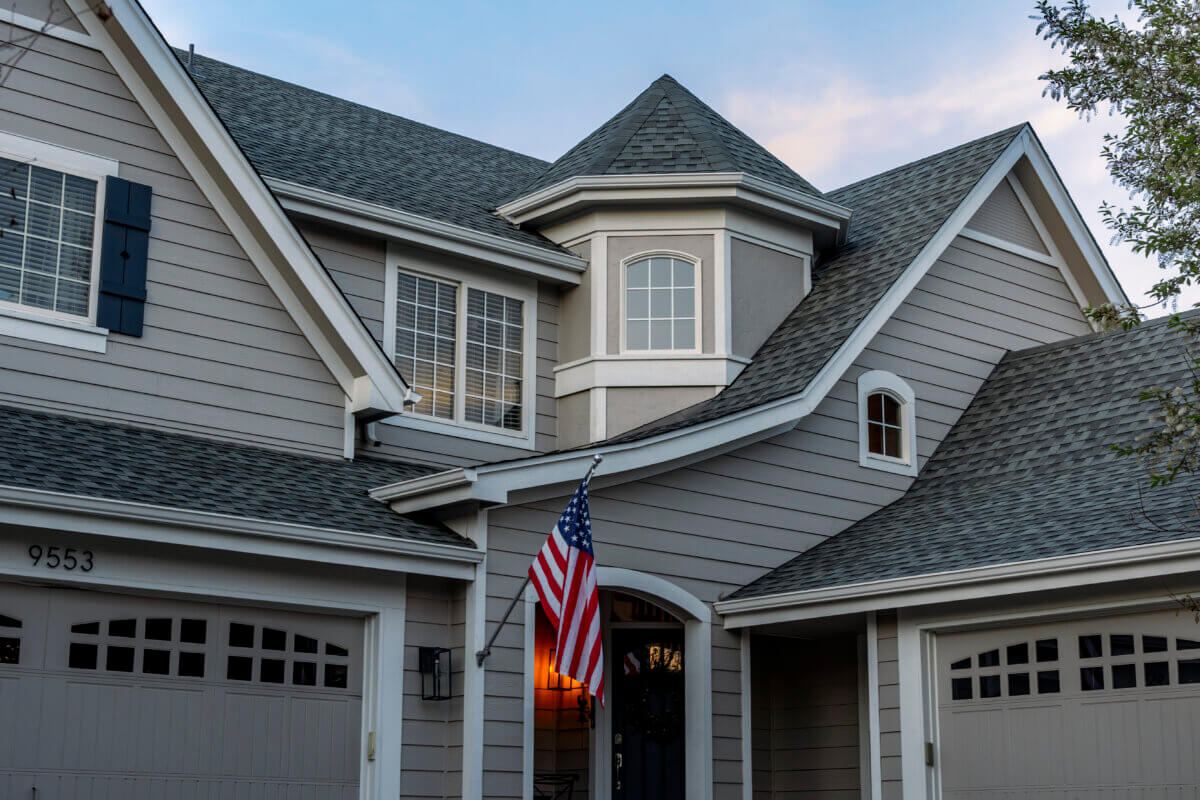 Completed residential roof on a two-storey home at dusk